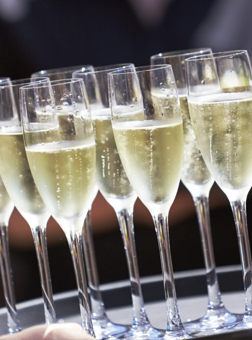 Tray of Champagne drinks being served on a sunny day outdoors