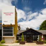 Exterior shot of Mercure Wetherby Hotel, front door and tower with ivy growing on the side