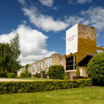 Exterior shot of Mercure Wetherby Hotel, front door and tower with ivy growing on the side