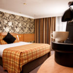 Nespresso coffee machine, with double bed in background in privilege bedroom