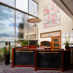 Reception desk at Mercure Wetherby Hotel, floor to ceiling windows