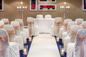 The Wharfedale Suite at Mercure Wetherby Hotel, set up for a wedding ceremony, white aisle, white chair covers