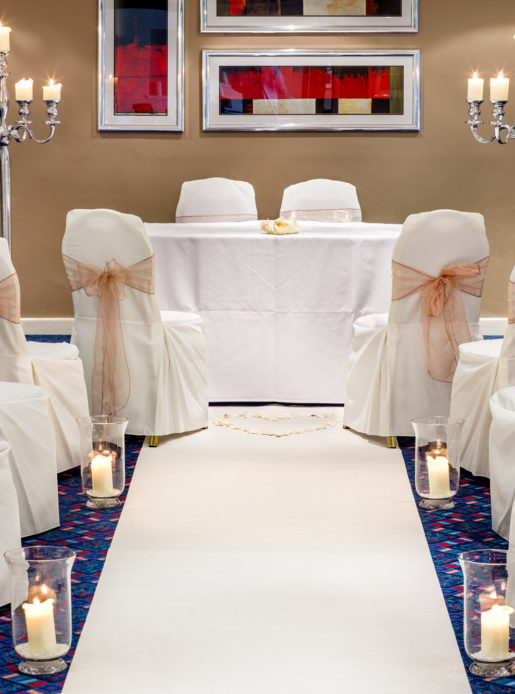 The Wharfedale Suite at Mercure Wetherby Hotel, set up for a wedding ceremony, white aisle, white chair covers